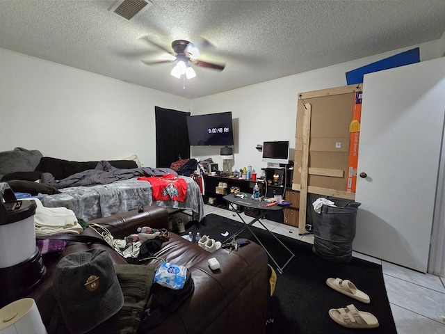 bedroom with a textured ceiling and a ceiling fan