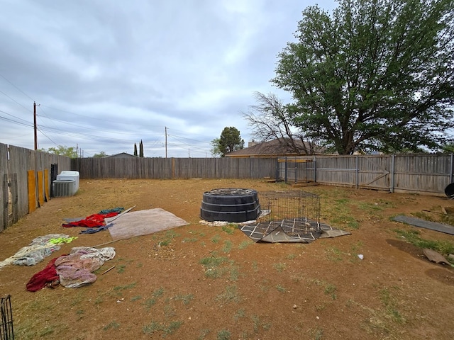 fenced backyard featuring an outdoor fire pit and cooling unit