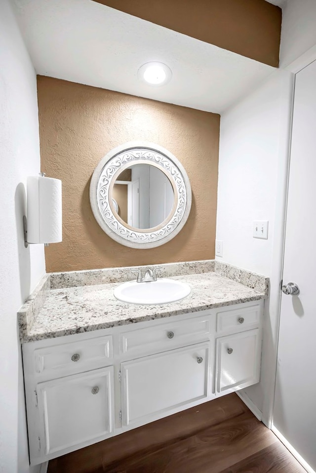 bathroom featuring hardwood / wood-style flooring and vanity