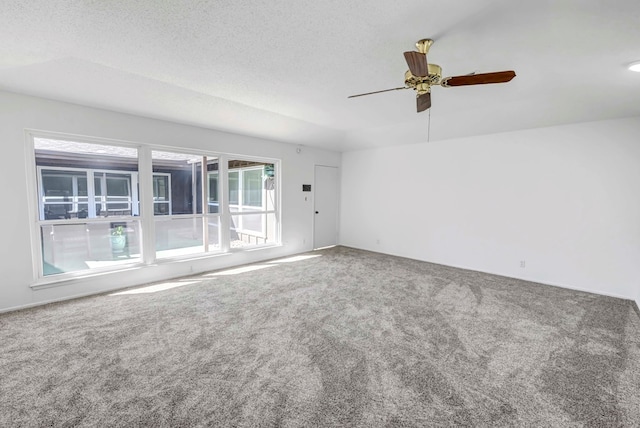 spare room with ceiling fan, carpet floors, and a textured ceiling