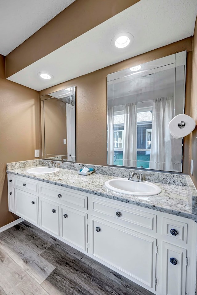 bathroom with vanity and wood-type flooring