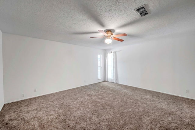 empty room featuring carpet floors, a textured ceiling, and ceiling fan