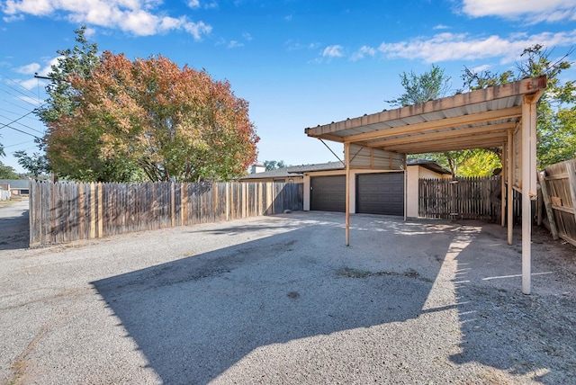 view of vehicle parking with a carport and a garage