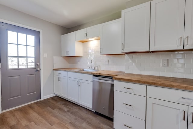 kitchen featuring dishwasher, white cabinetry, butcher block counters, and sink