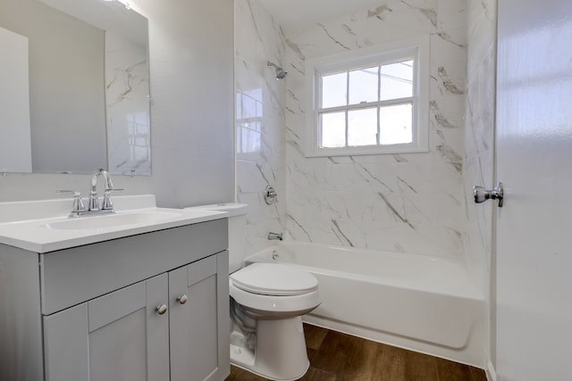 full bathroom featuring wood-type flooring, vanity, toilet, and tiled shower / bath