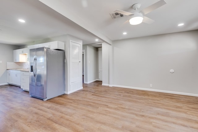 kitchen featuring white cabinets, sink, ceiling fan, light wood-type flooring, and stainless steel fridge with ice dispenser