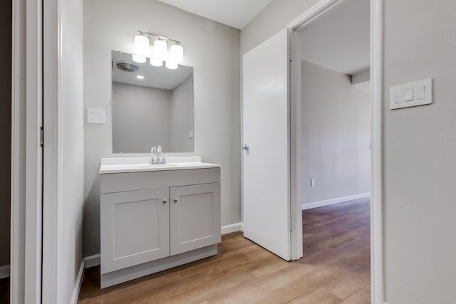 bathroom with hardwood / wood-style flooring and vanity