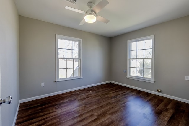 unfurnished room with ceiling fan, plenty of natural light, and dark hardwood / wood-style floors