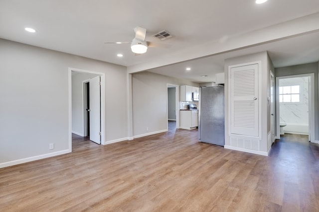 unfurnished living room with light wood-type flooring and ceiling fan