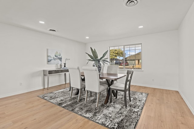 dining space with light hardwood / wood-style flooring