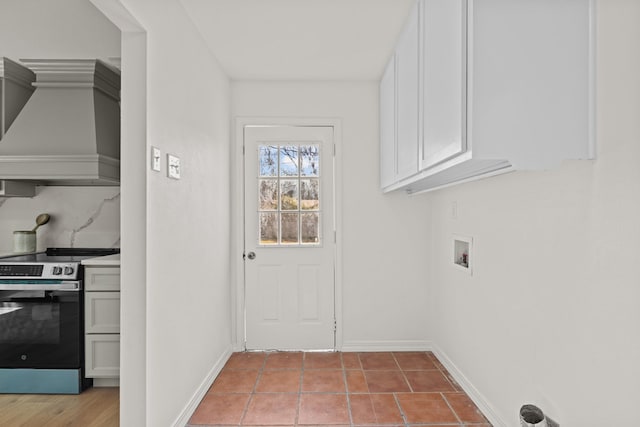 clothes washing area with washer hookup and light tile patterned floors