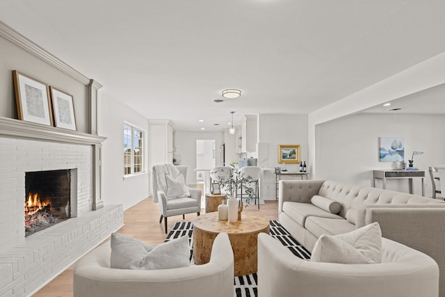 living room featuring a fireplace and light hardwood / wood-style flooring