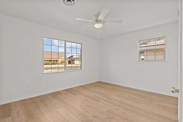 spare room with light hardwood / wood-style floors and ceiling fan