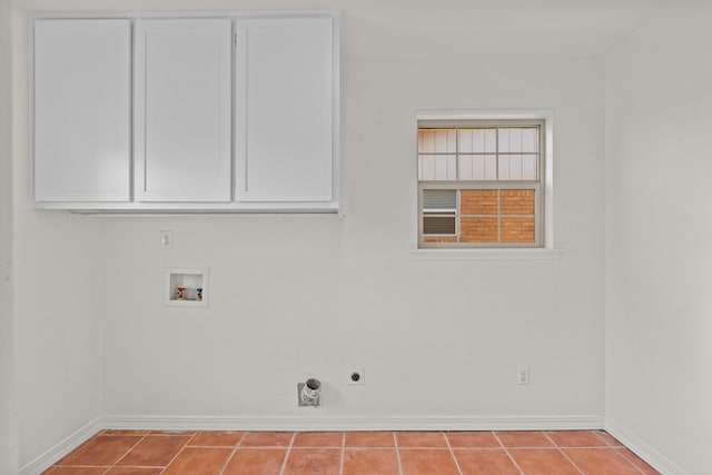 laundry area with hookup for a washing machine, cabinets, hookup for an electric dryer, and light tile patterned floors