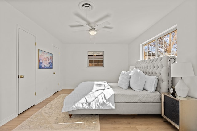 bedroom with ceiling fan and light hardwood / wood-style floors