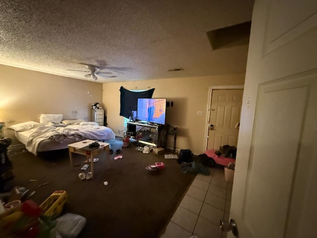 106 Walcott, Midland, TX 79701 - bedroom with tile patterned flooring, a textured ceiling, and a ceiling fan