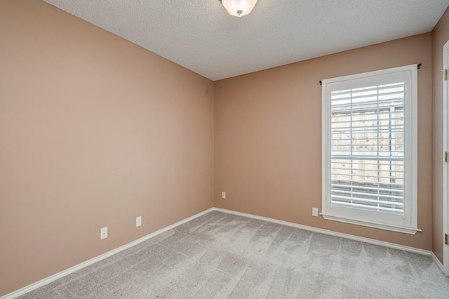 1608 Castleford Rd, Midland, TX 79705 - unfurnished room featuring baseboards, a textured ceiling, and light carpet