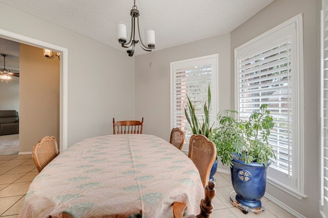 1608 Castleford Rd, Midland, TX 79705 - dining space with light tile patterned floors, a textured ceiling, and a healthy amount of sunlight