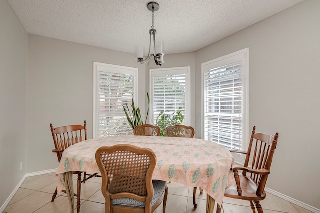 1608 Castleford Rd, Midland, TX 79705 - dining area with baseboards, a textured ceiling, and a chandelier