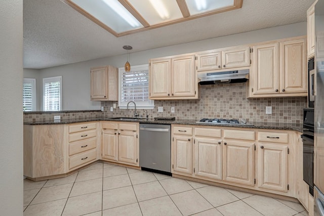 1608 Castleford Rd, Midland, TX 79705 - kitchen with under cabinet range hood, stainless steel appliances, a sink, and light brown cabinets