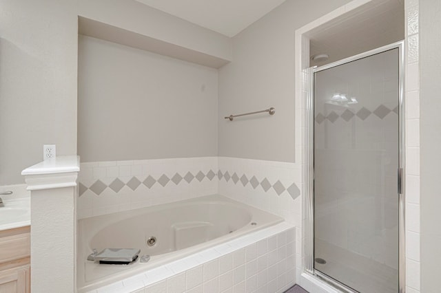 1608 Castleford Rd, Midland, TX 79705 - full bathroom featuring vanity, a shower stall, and a jetted tub