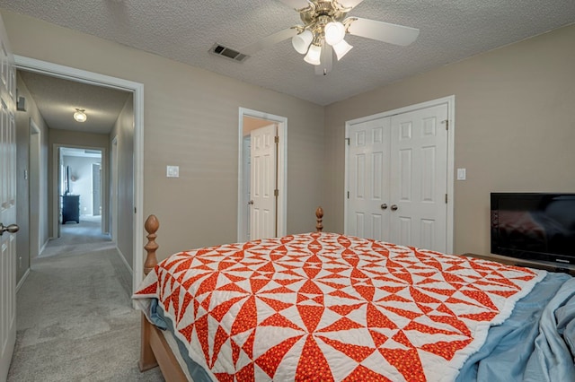 1608 Castleford Rd, Midland, TX 79705 - bedroom featuring visible vents, a textured ceiling, a closet, and light carpet