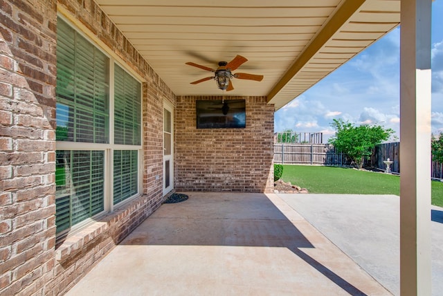 view of patio / terrace with a ceiling fan and fence