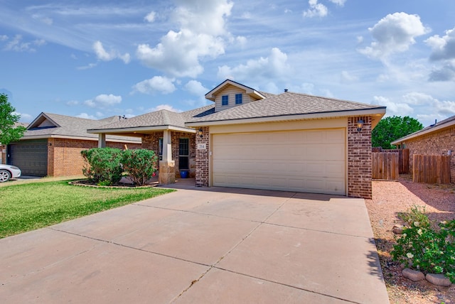 view of front facade with brick siding, an attached garage, fence, and concrete driveway