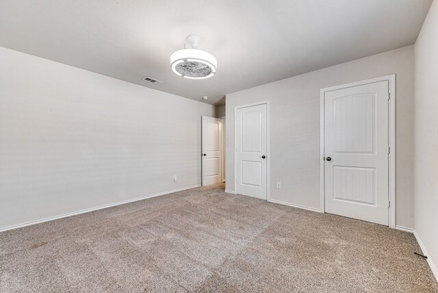 unfurnished bedroom with visible vents, baseboards, and carpet floors