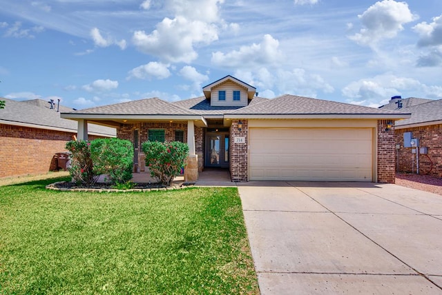 prairie-style home featuring brick siding, a front lawn, an attached garage, and driveway
