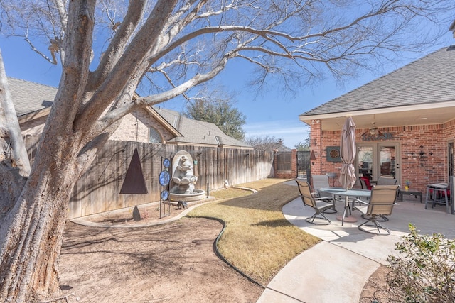 view of yard with a patio, fence private yard, and ceiling fan