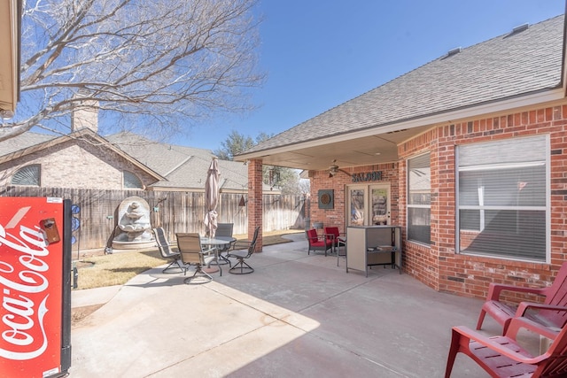 view of patio featuring outdoor dining space and fence