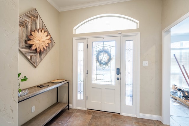 entryway featuring baseboards, plenty of natural light, and ornamental molding