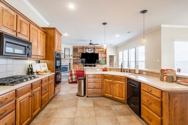 kitchen featuring black appliances, brown cabinets, open floor plan, and ornamental molding