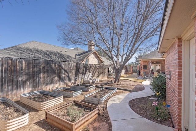 view of patio with a fenced backyard and a garden