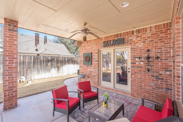 view of patio / terrace featuring a ceiling fan, fence, and french doors