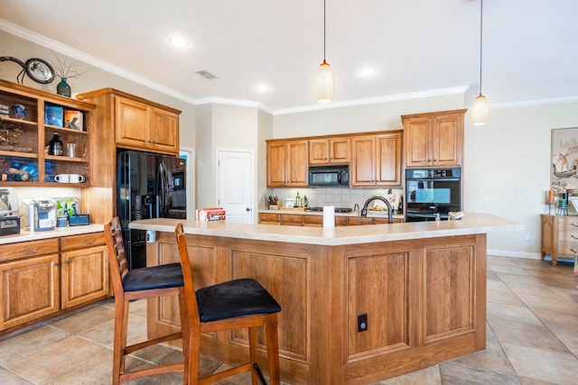 kitchen featuring black appliances, visible vents, backsplash, and brown cabinets