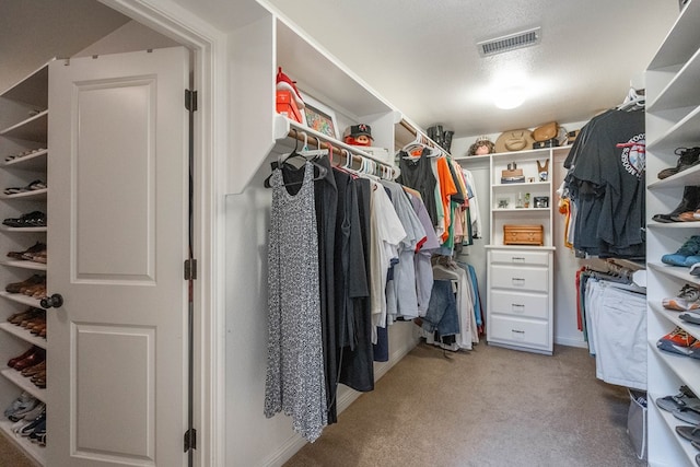 walk in closet featuring light carpet and visible vents