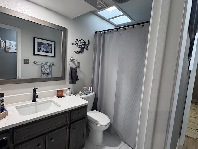 3212 Fannin Ave, Midland, TX 79705 - bathroom featuring a skylight, vanity, a shower with shower curtain, and tile patterned floors