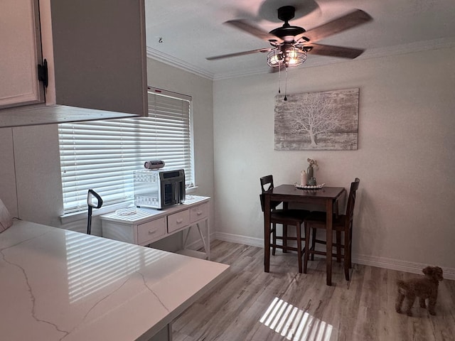 3212 Fannin Ave, Midland, TX 79705 - dining area with ornamental molding, a ceiling fan, and light wood finished floors