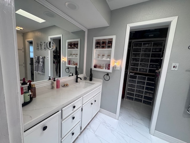 3212 Fannin Ave, Midland, TX 79705 - bathroom featuring double vanity and marble look tiles