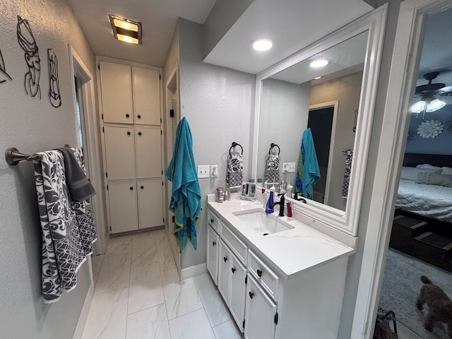 3212 Fannin Ave, Midland, TX 79705 - bathroom featuring marble look tiles, vanity, and recessed lighting