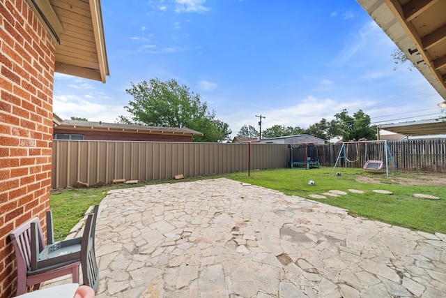407 Edwards Blvd, Big Spring, TX 79720 - fenced backyard with a playground and a patio