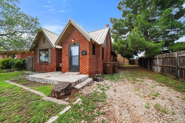 407 Edwards Blvd, Big Spring, TX 79720 - view of front of property featuring a metal roof, brick siding, and a standing seam roof