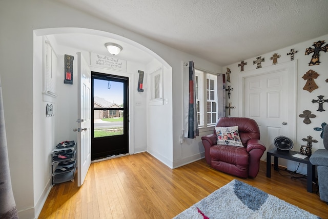 407 Edwards Blvd, Big Spring, TX 79720 - entryway featuring arched walkways, light wood-style floors, and a textured ceiling