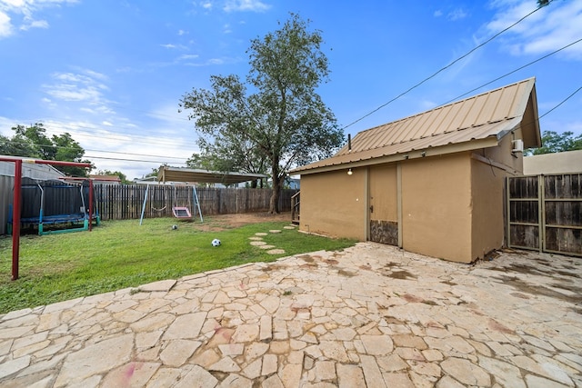 407 Edwards Blvd, Big Spring, TX 79720 - fenced backyard with a trampoline and a patio