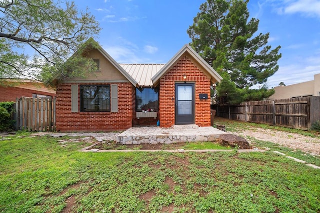 407 Edwards Blvd, Big Spring, TX 79720 - view of front facade featuring brick siding and a metal roof