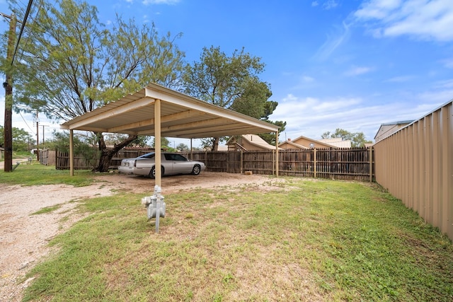 407 Edwards Blvd, Big Spring, TX 79720 - fenced backyard featuring a carport and driveway