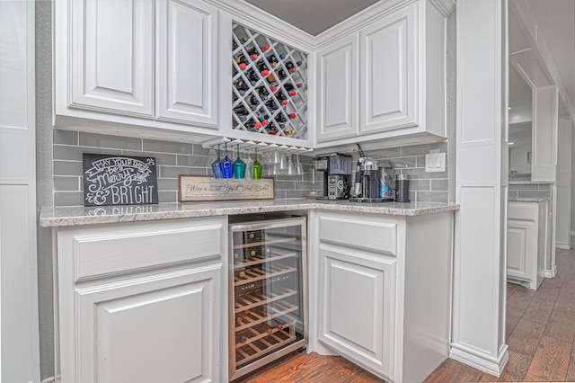 4100 Skyline Dr, Midland, TX 79707 - indoor dry bar with wine cooler, tasteful backsplash, and wood finished floors