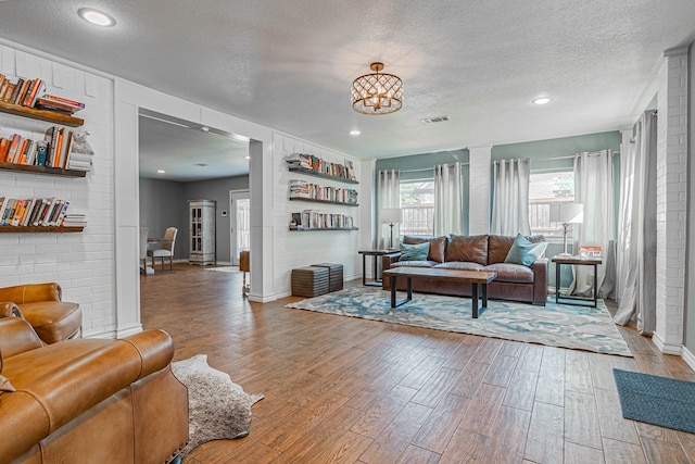 4100 Skyline Dr, Midland, TX 79707 - living room featuring wood finished floors, a textured ceiling, and a chandelier